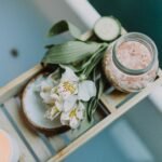 a bath salt and flowers on a tray